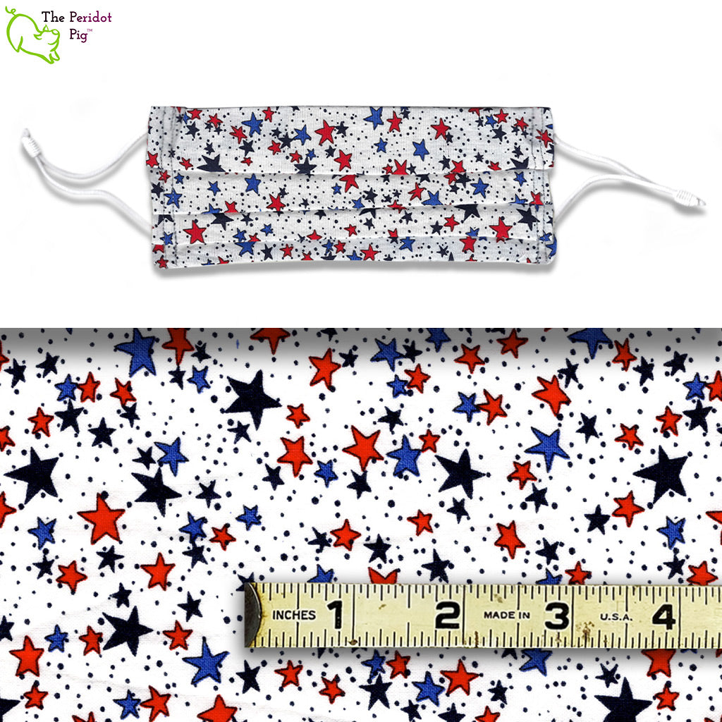 A view showing the mask and the scale of the pattern. The Super Stars fabric pattern is perfect for letting that particular person in your life know how great you think they are. Full of whimsical stars in red, blue and black set on a white background.