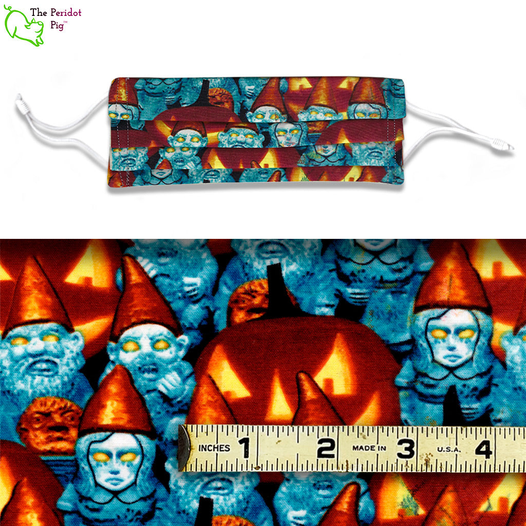 Blue toned zombie garden gnomes with glowing yellow eyes amid jack-o-lanterns. The Zombie Gnomes fabric glows in the dark too! A view of the mask and the fabric scale.